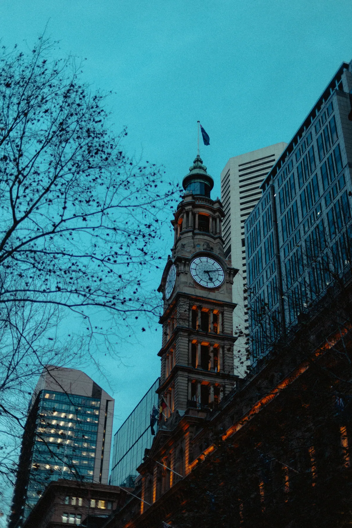 The GPO clock tower against a teal evening sky, office towers behind