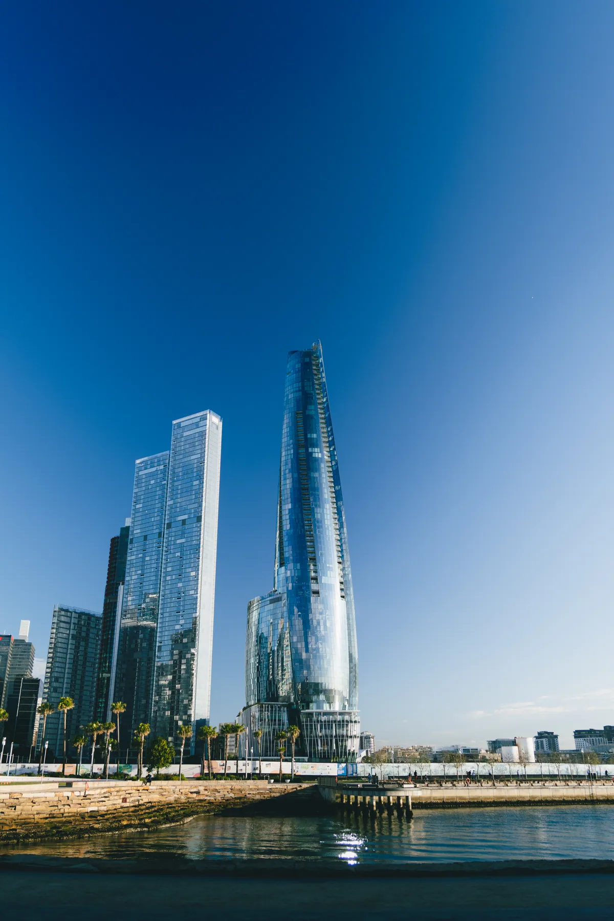 Barangaroo towers reflected over the water from the harbour foreshore